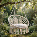 Macramé hammock swing chair, hand-knotted, hanging on a garden porch in BC