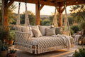 Macramé porch swing bed in hand-knotted natural cotton on a wooden porch